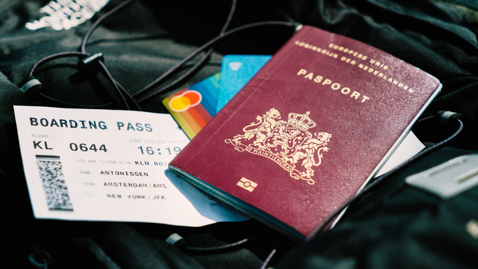 A passport and a boarding pass resting on a travel bag