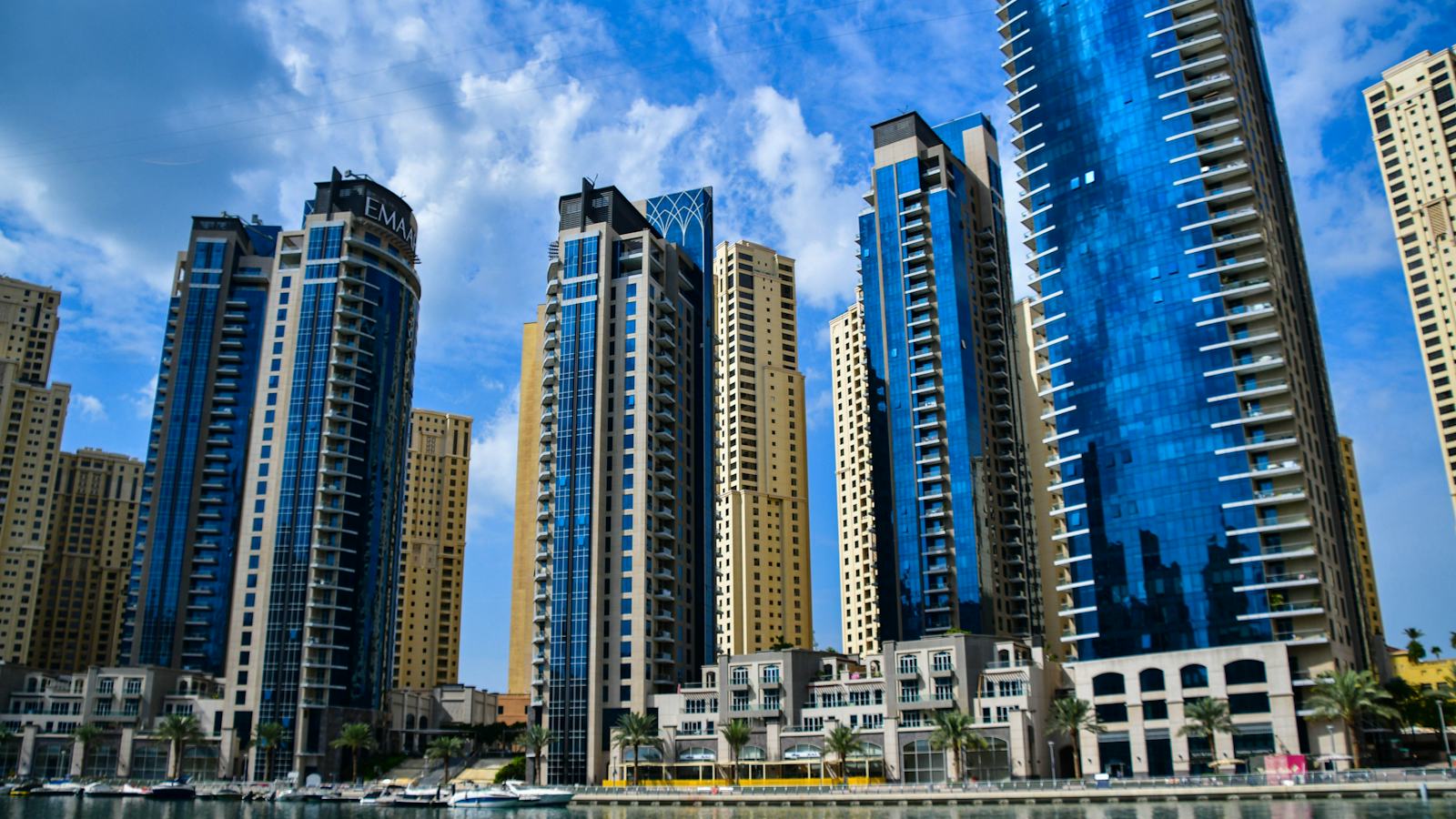 Waterfront towers of Dubai Marina under a blue sky