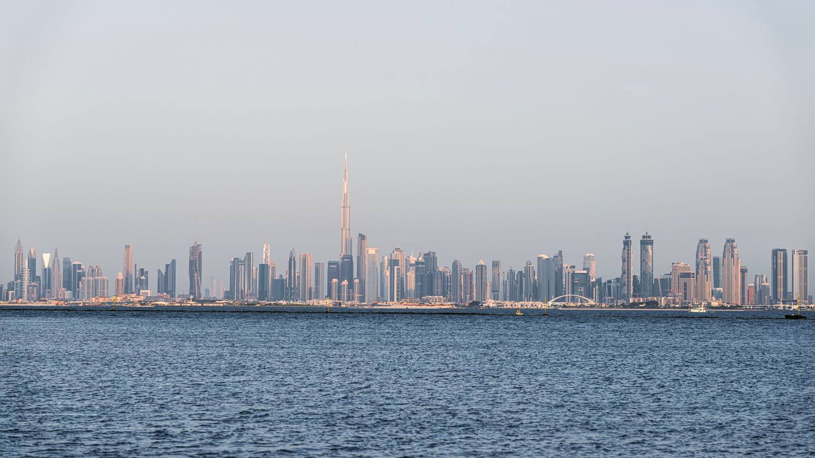 The Dubai skyline with the Burj Khalifa seen across the water.