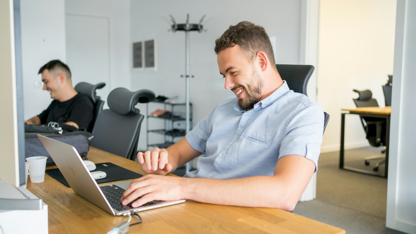 A man working on a laptop in a bright office