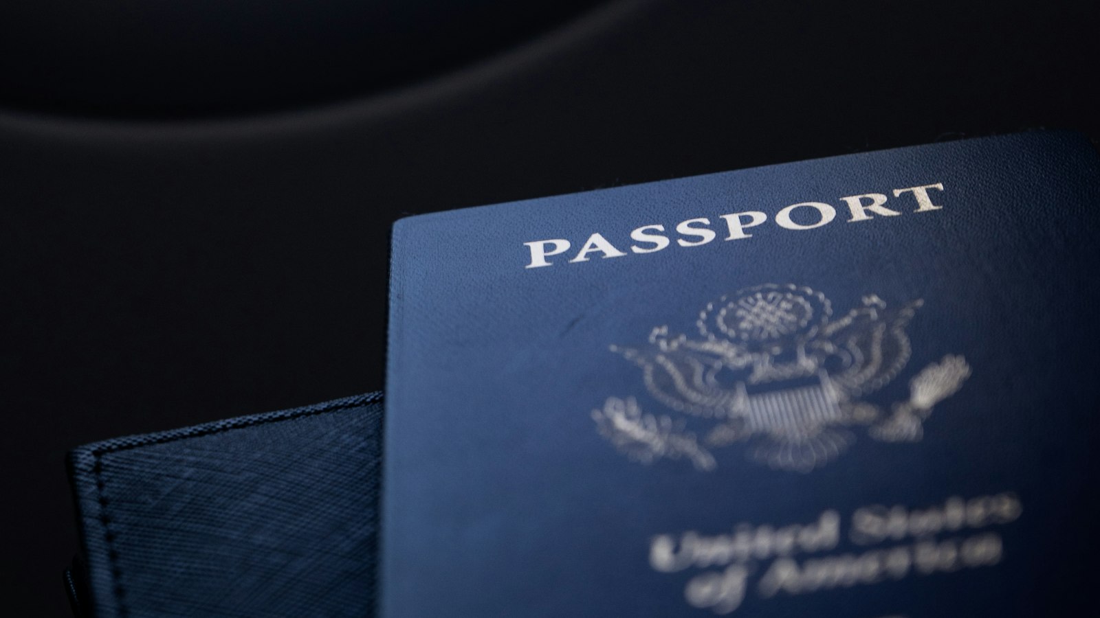 A close-up of a passport on a dark surface